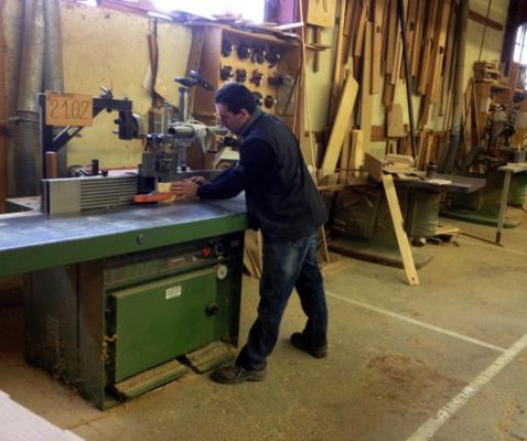 Our factory chief, Olivier is here working on wood with a wood shaper.